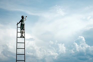 Child on ladder reaching to the sky